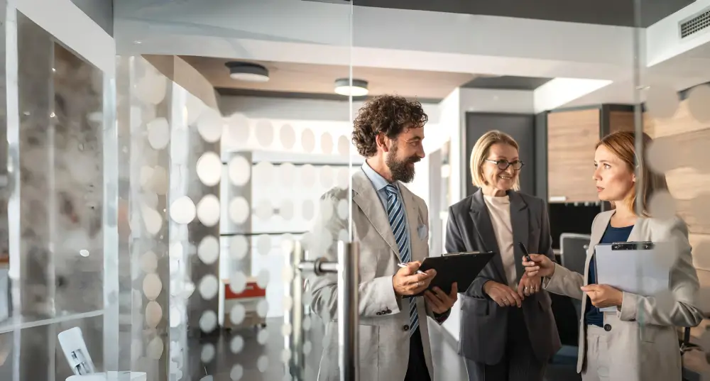 Business meeting in modern glass office.