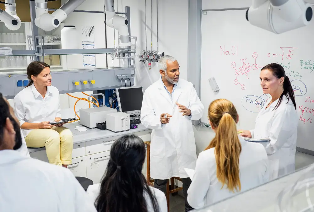 Scientists discussing research in a laboratory setting.